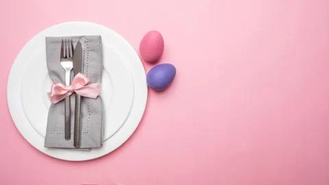 Easter table, place setting. Easter eggs, pastel colors painted and white pla Stock Photos