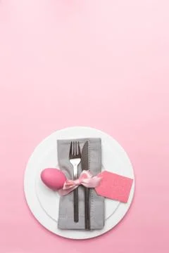 Easter table, place setting. Easter egg, pink color painted in a white plate, Stock Photos
