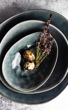 Easter table with Quail eggs and lavender in a stack of ceramic bowls Stock Photos