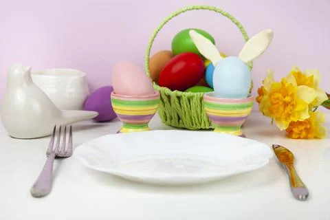 Easter table setting and dinner with festive decorations. Stock Photos