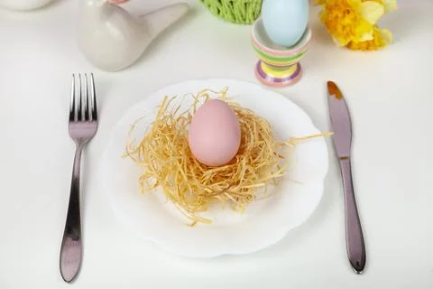 Easter table setting and dinner with  multicolored eggs. Stock Photos