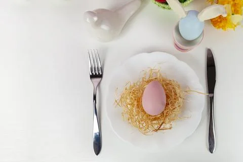 Easter table setting and dinner with  multicolored eggs. Stock Photos