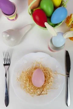 Easter table setting and dinner with  multicolored eggs. Stock Photos