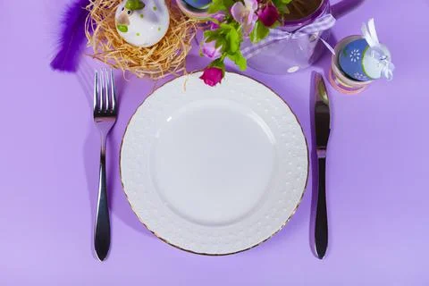 Easter table setting and dinner with yellow flowers, festive decorations, whi Stock Photos