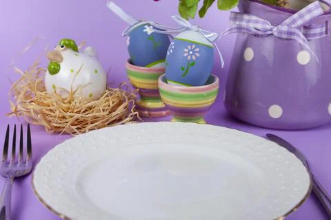 Easter table setting and dinner with yellow flowers, festive decorations, whi Stock Photos