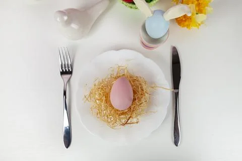 Easter table setting and dinner with  multicolored eggs. Stock Photos