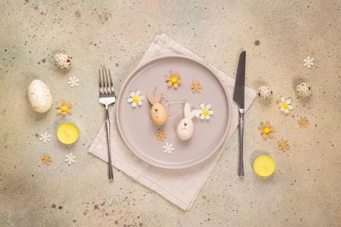 Easter table setting with bunny eggs and flowers Stock Photos