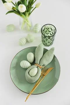 Easter Table Setting with Bunny Napkin, Decorated Eggs and Tulips. Festive .. Stock Photos