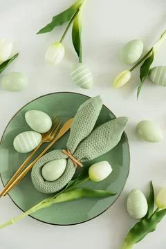 Easter Table Setting with Bunny Napkin, Decorated Eggs and Tulips. Festive .. Stock Photos