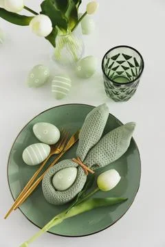 Easter Table Setting with Bunny Napkin, Decorated Eggs and Tulips. Festive .. Stock Photos