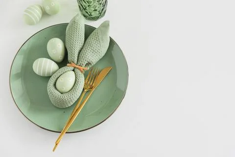 Easter Table Setting with Bunny Napkin, Decorated Eggs and Tulips. Festive .. Stock Photos
