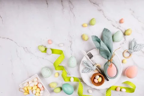 Easter Table Setting with Bunny Napkin and Colorful Eggs Stock Photos