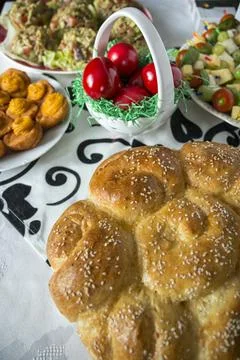 Easter table setting with colored red eggs, bread, green branches decorated Stock-Fotos