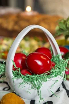 Easter table setting with colored red eggs, bread, green branches decorated.. Stock Photos