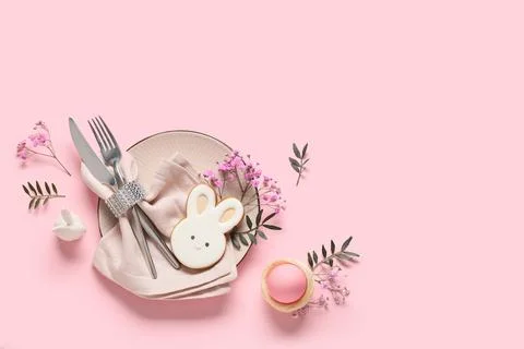 Easter table setting with cookie in shape of bunny, egg, olive branches and g Stock Photos