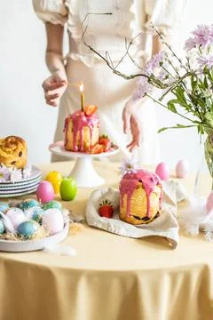 Easter table setting. Easter cake craffin. Woman on background Stock Photos