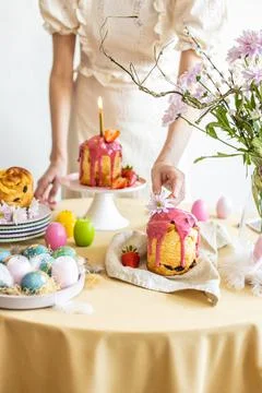 Easter table setting. Easter cake craffin. Woman on background Stock Photos
