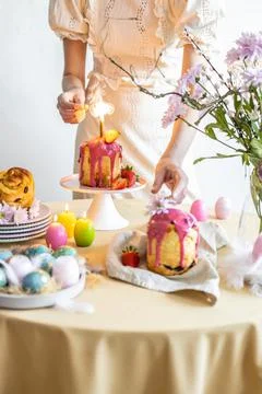 Easter table setting. Easter cake craffin. Woman on background Stock Photos