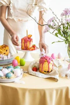 Easter table setting. Easter cake craffin. Woman on background Stock Photos