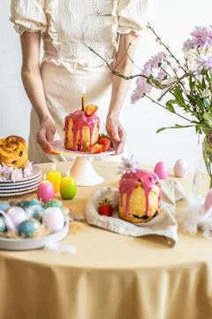 Easter table setting. Easter cake craffin. Woman on background Stock Photos