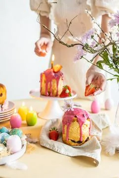 Easter table setting. Easter cake craffin. Woman on background Stock Photos
