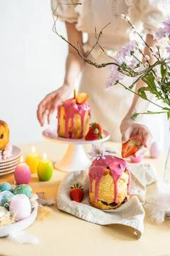 Easter table setting. Easter cake craffin. Woman on background Stock Photos