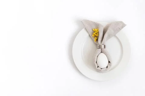 Easter table setting with egg in gray napkin Easter Bunny  Stock Photos