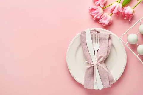 Easter table setting with floral decor on pink table. Elegance dinner. Mock u Stock Photos