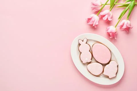 Easter table setting with floral decor and plate with easter gingerbread on p Stock Photos