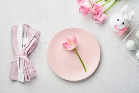 Easter table setting with floral decor on gray table. Elegance dinner. Mock u Stock Photos