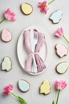 Easter table setting with floral decor on gray table. Elegance dinner. Mock u Stock Photos