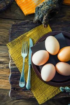 Easter table setting. Fresh eggs on plate. Spring table. Flatlay overhead sho Stock Photos