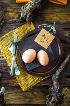 Easter table setting. Fresh eggs on plate. Spring table. Flatlay overhead sho Stock Photos
