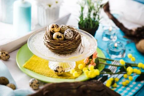 Easter table setting. Fresh eggs on plate. Spring table. Stock Photos
