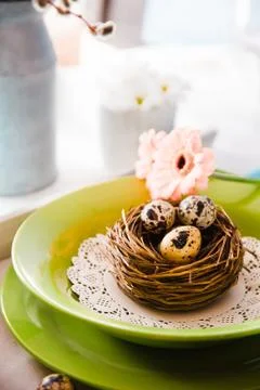 Easter table setting. Fresh eggs on plate. Spring table. Stock Photos