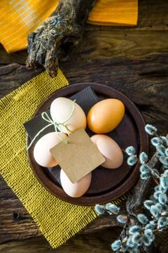 Easter table setting. Fresh eggs on plate. Spring table. Flatlay overhead sho Stock Photos