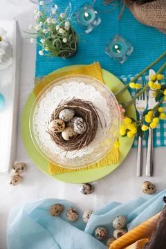 Easter table setting. Fresh eggs on plate. Spring table. Stock Photos