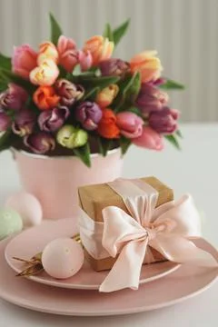 Easter Table Setting with Gift Box, Decorated Eggs and Tulips. Festive Spri.. Stock Photos