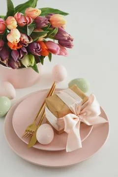 Easter Table Setting with Gift Box, Decorated Eggs and Tulips. Festive Spri.. Stock Photos