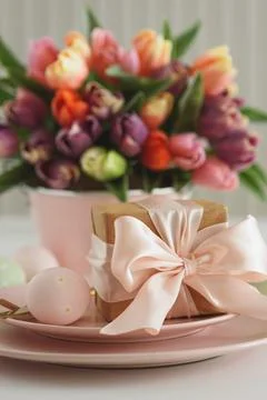 Easter Table Setting with Gift Box, Decorated Eggs and Tulips. Festive Spri.. Stock Photos