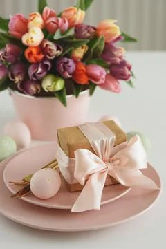 Easter Table Setting with Gift Box, Decorated Eggs and Tulips. Festive Spri.. Stock Photos