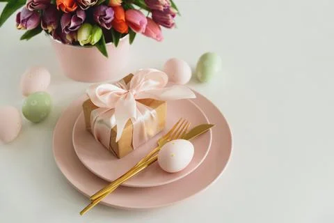 Easter Table Setting with Gift Box, Decorated Eggs and Tulips. Festive Spri.. Stock Photos