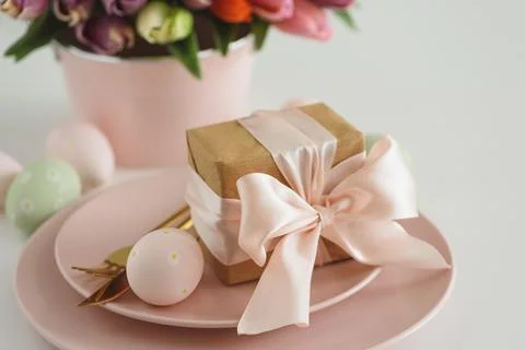 Easter Table Setting with Gift Box, Decorated Eggs and Tulips. Festive Spri.. Stock Photos