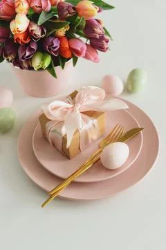 Easter Table Setting with Gift Box, Decorated Eggs and Tulips. Festive Spri.. Stock Photos