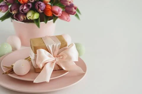 Easter Table Setting with Gift Box, Decorated Eggs and Tulips. Festive Spri.. Stock Photos