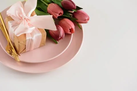 Easter Table Setting with Gift Box, Decorated Eggs and Tulips. Festive Spri.. Stock Photos