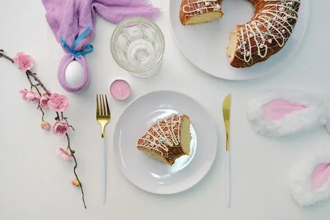 Easter table setting, glazed Easter cake and candles on table decorated for.. Stock Photos