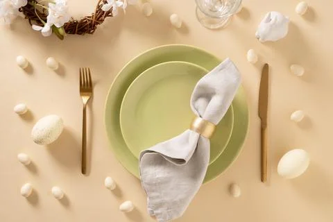 Easter table setting with green plate, cookies, eggs and bunny. Stock Photos