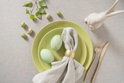Easter table setting with green plates and decorative eggs Stock Photos