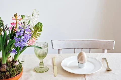 Easter table setting from hyacinths flowers and quail eggs on linen tablecloth Stock Photos